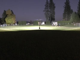 Lentry Light in the distance illuminates a soccer field during practice. Click to see larger image.